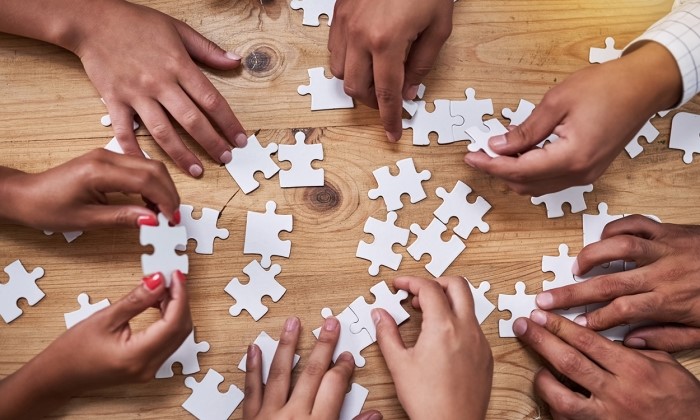 Hands putting together a puzzle