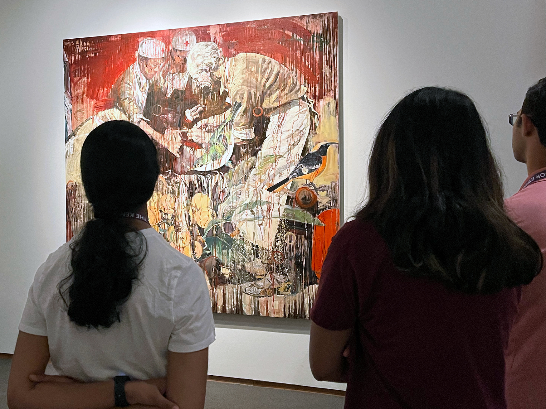Students look at a colorful painting