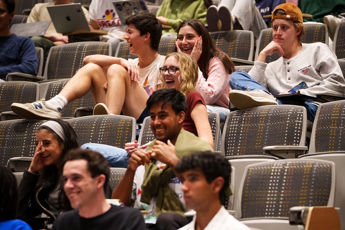 Students laugh in their seats.