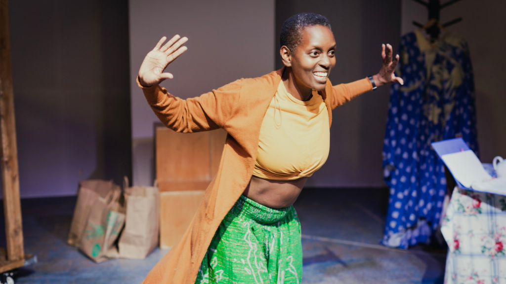 A woman gestures onstage.