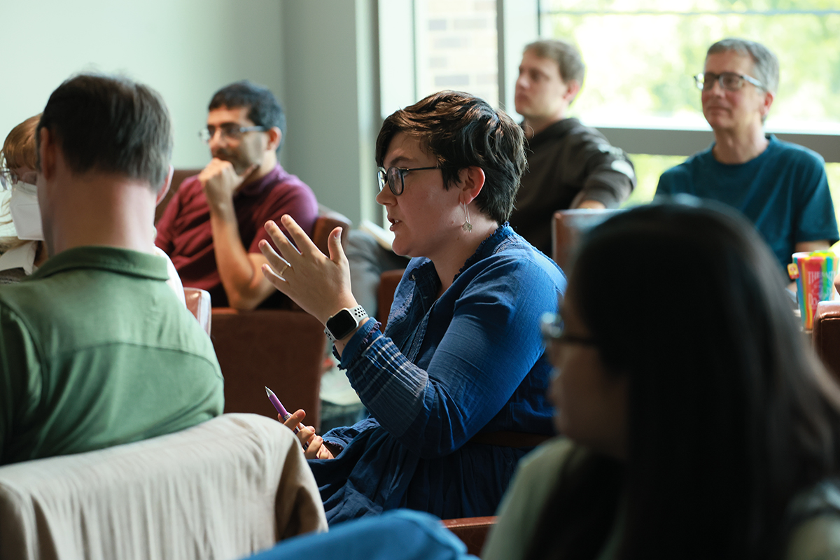 A woman gestures in a seminar